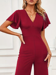 Burgundy flutter sleeve V-neck wide-leg jumpsuit with a cinched waist.