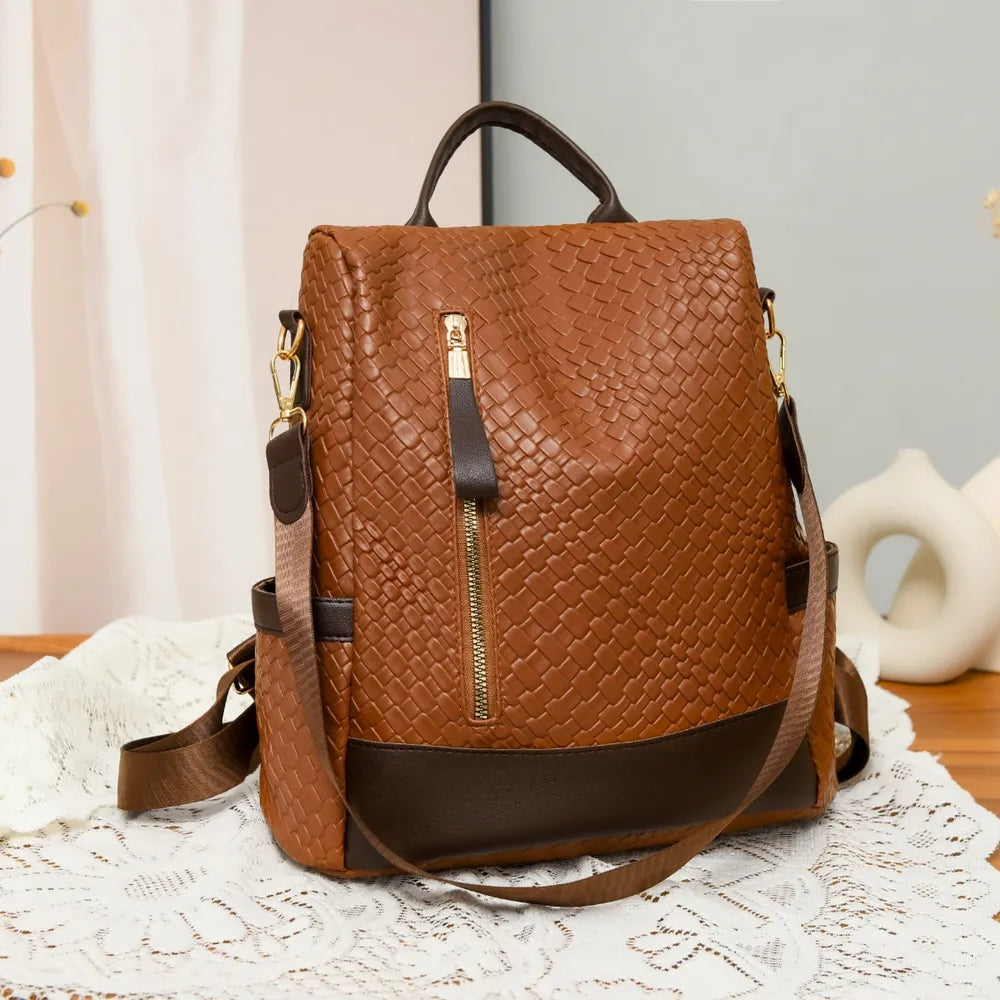 Brown woven faux leather convertible backpack with gold zipper detail.