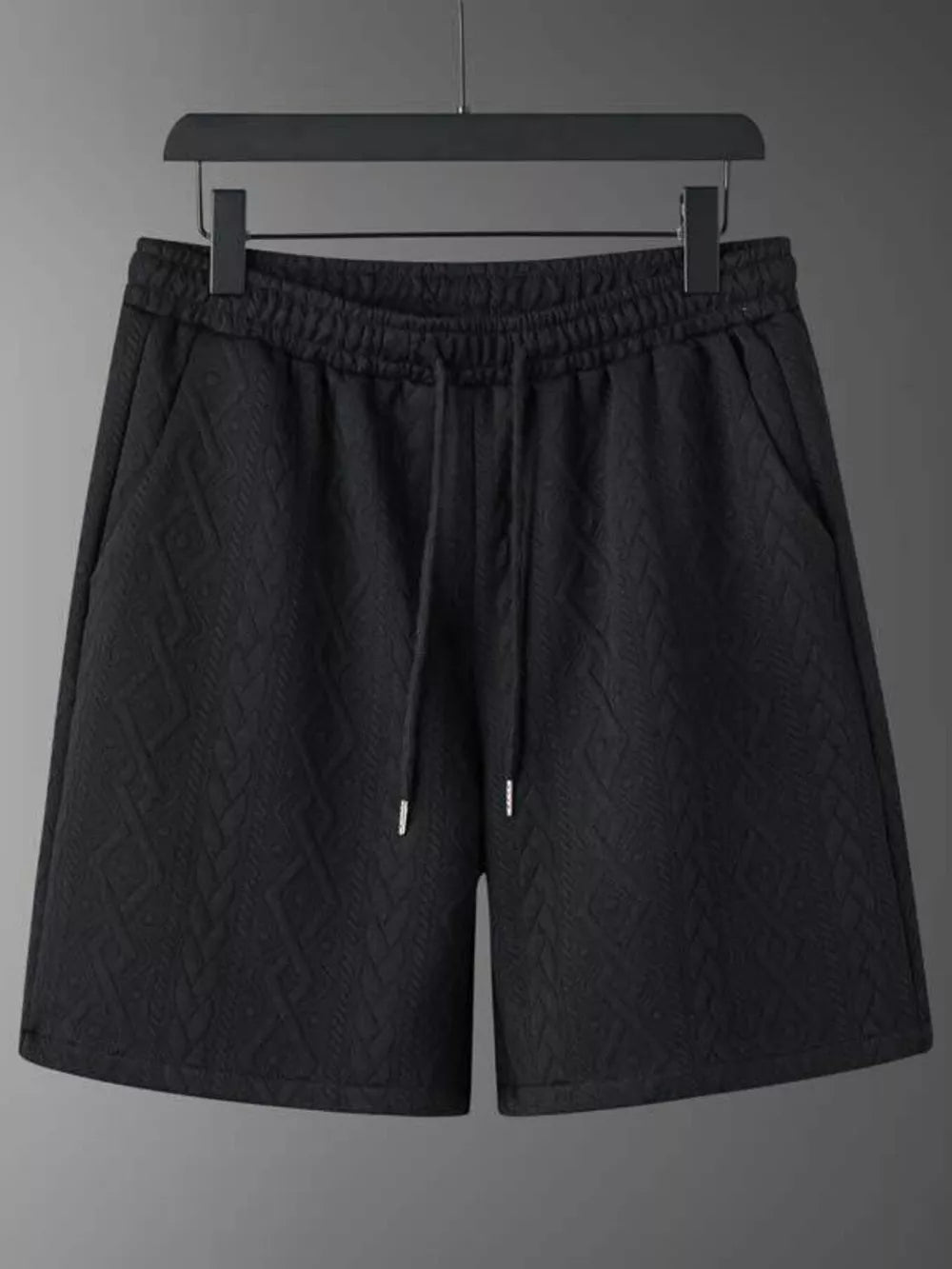 Black textured knit shorts with drawstring and pockets.