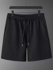 Black textured knit shorts with drawstring and pockets.