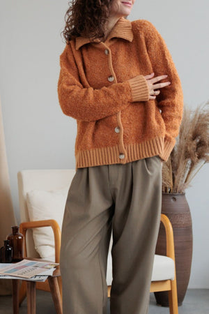 Textured bouclé collar cardigan in tangerine with button front and ribbed trim.