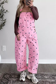 Pink polka dot denim overalls with bib pocket and button side detail