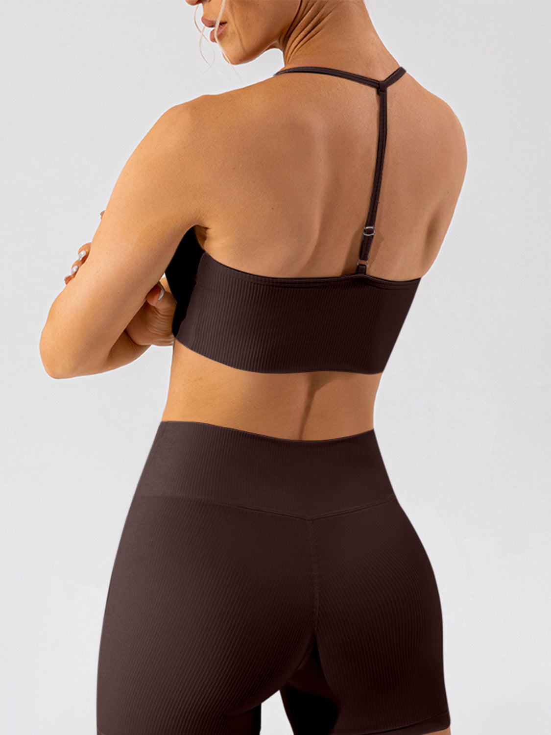 Ribbed halterneck active bra in chocolate with adjustable straps and a racerback detail.