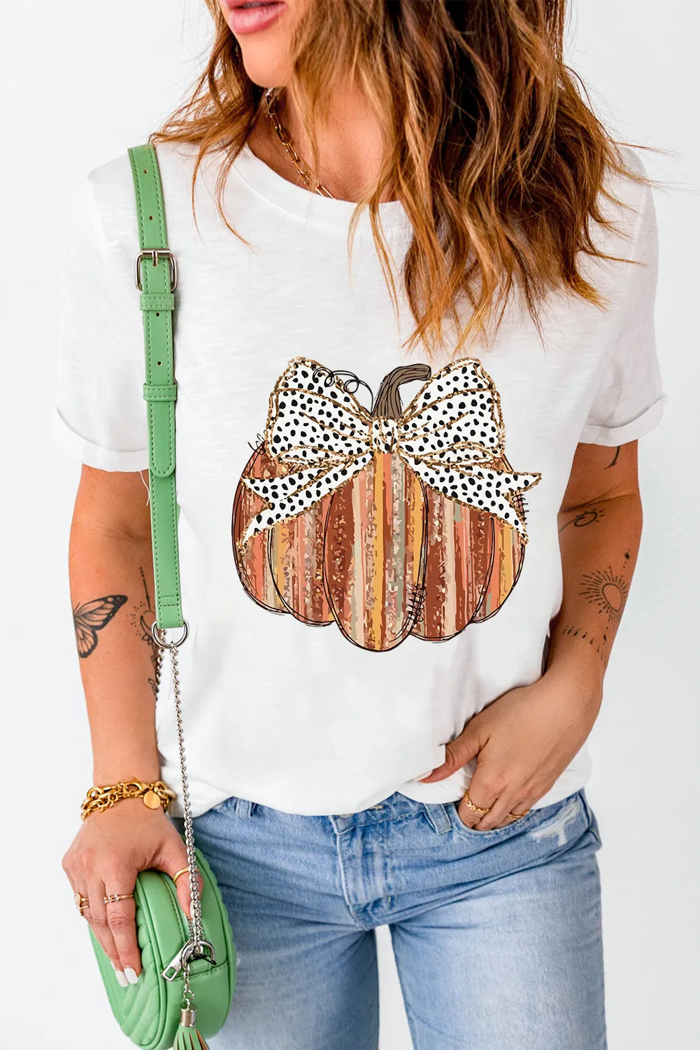 White t-shirt with striped pumpkin graphic and dalmatian print bow detail
