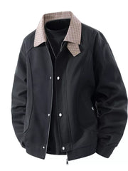 Black zip-up jacket with plaid collar and button details, styled over a black turtleneck.