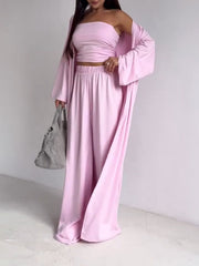 Blush pink three-piece outfit set with ruched strapless top, wide-leg pants, and long-sleeve cardigan.