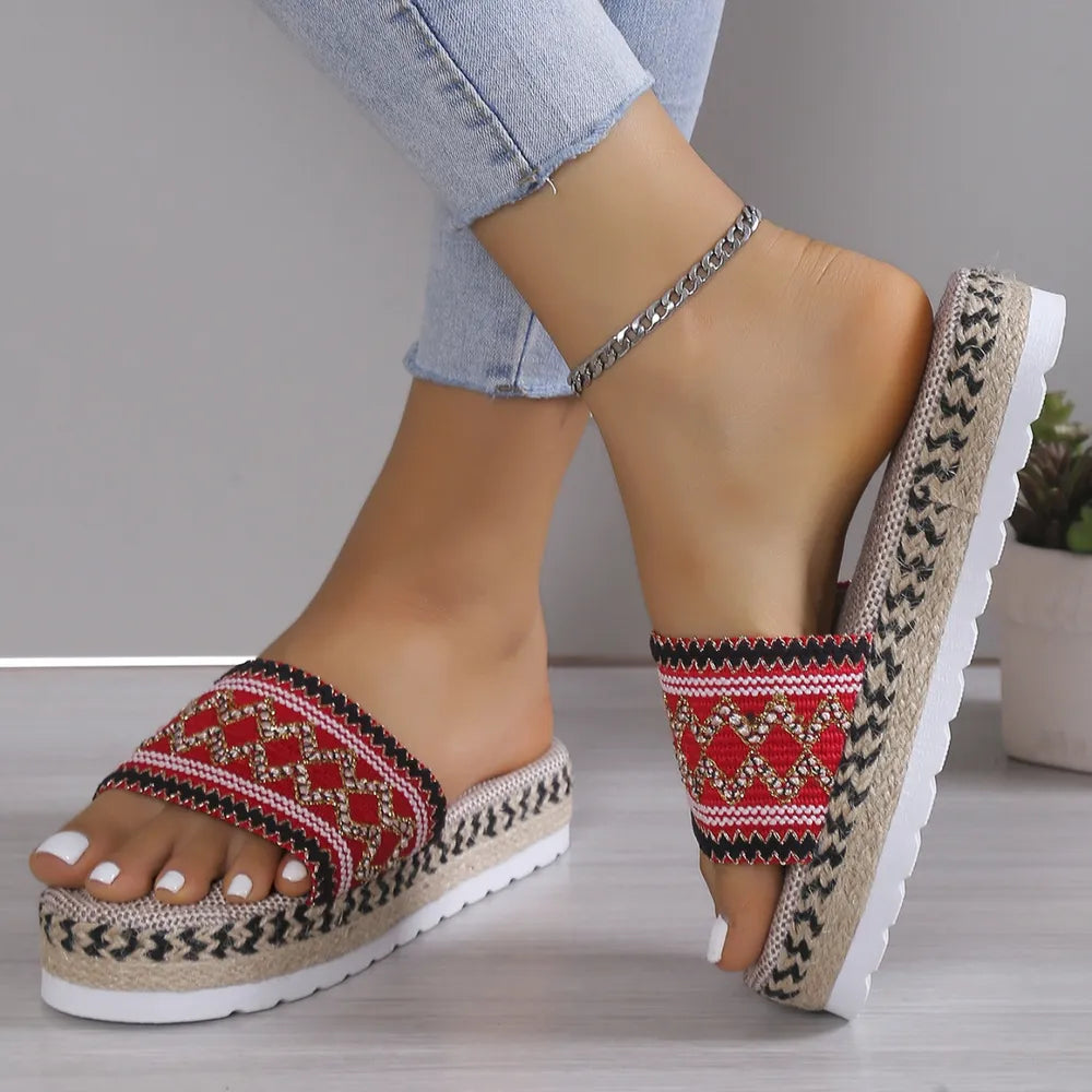 Embroidered platform espadrille slides in red with woven jute sole and white pedicure.