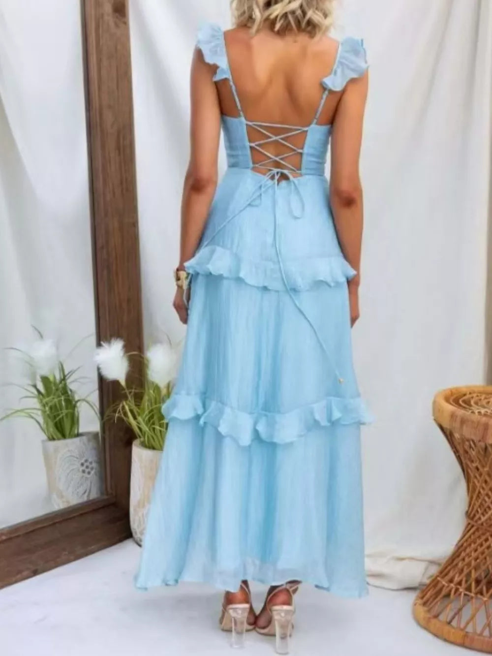 Aqua ruffled maxi dress with lace-up back detail and tiered skirt.