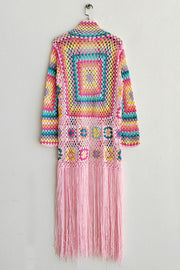 Granny square crochet duster in blush pink with colorful squares and long fringe detail