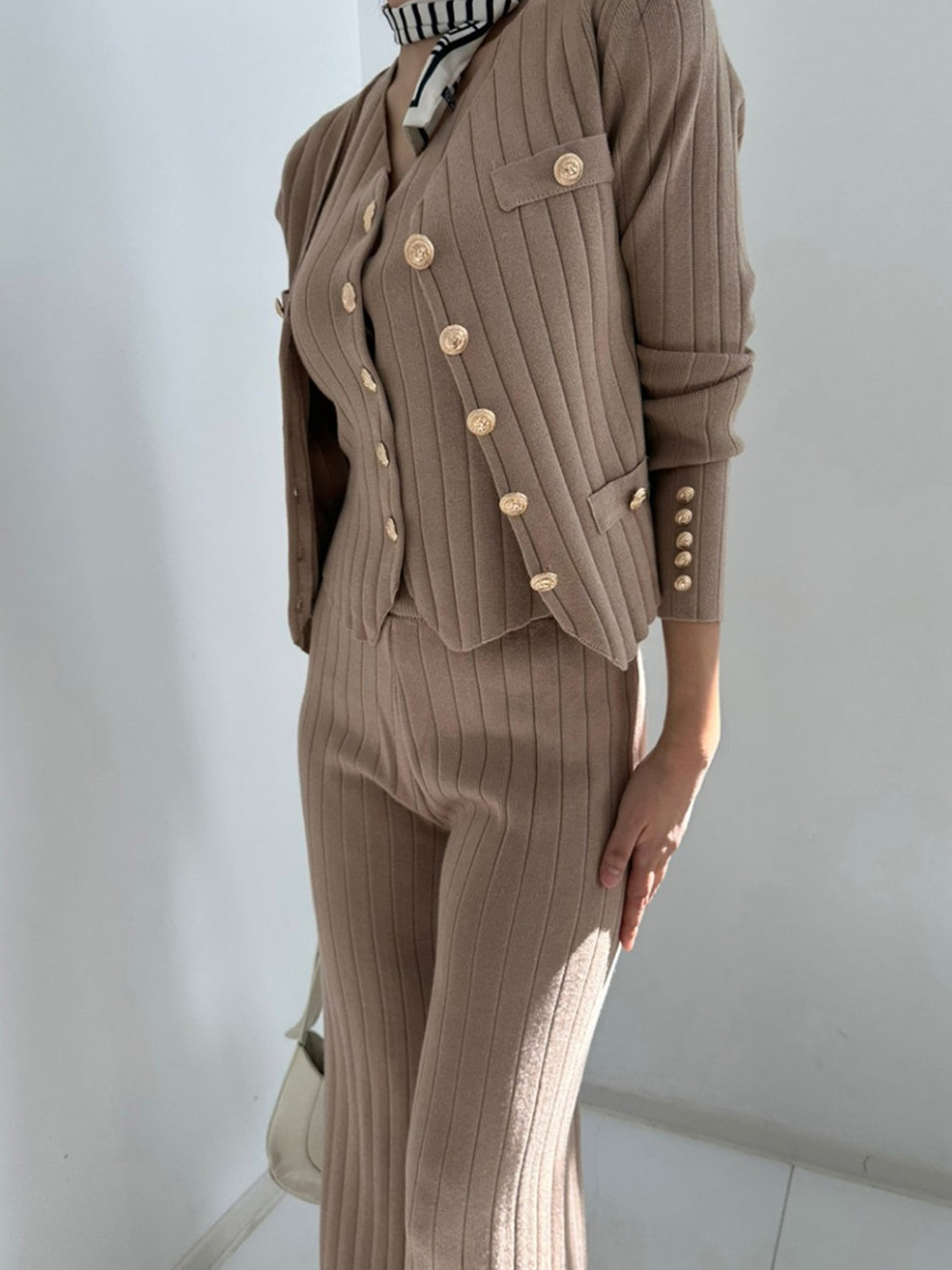 Taupe ribbed knit ensemble with gold buttons, featuring a cardigan and pants.