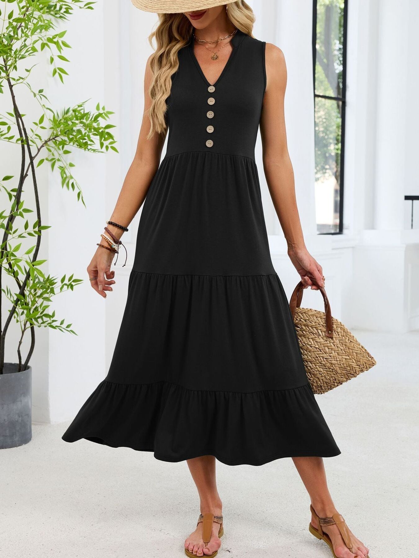 Black tiered midi dress with V-neck and decorative buttons.