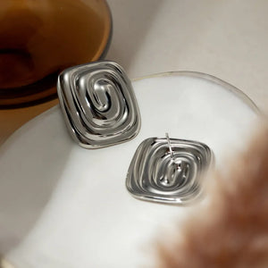 Sculpted swirl square earrings in silver with a polished finish and contemporary design.