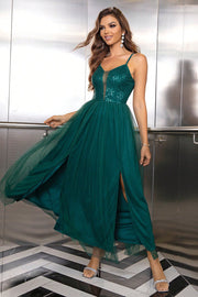 Emerald sequin bodice maxi dress with double slit skirt and tulle overlay.