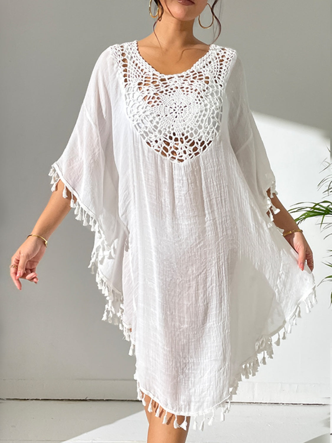White crochet yoke tassel kaftan dress with short sleeves and a V-neckline.