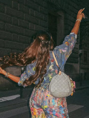 Denim button-up shirt with colorful artistic paint splatters, long sleeves, relaxed fit.