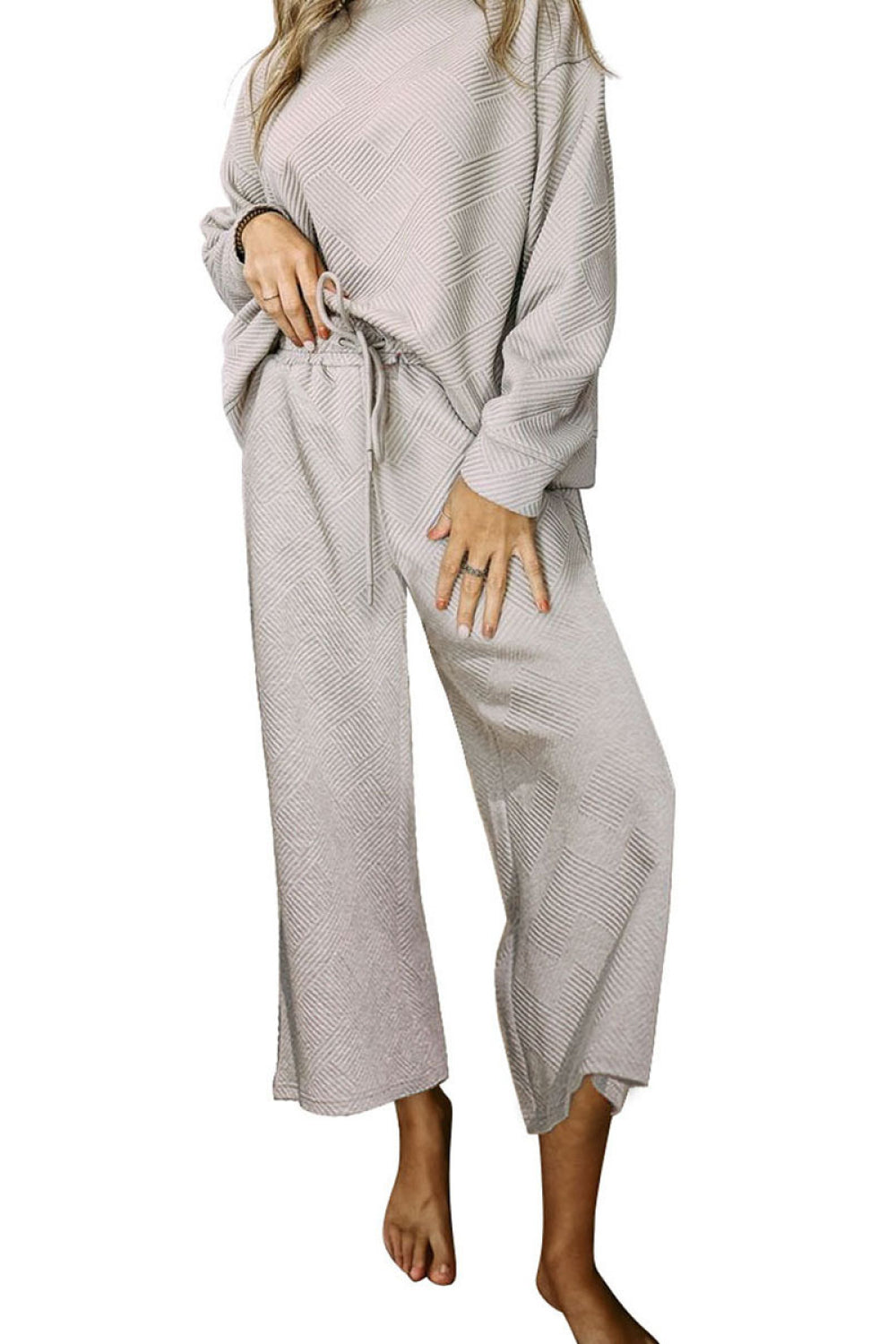 Light gray loungewear set with textured geometric pattern, crew neck, drop sleeves, and drawstring pants.