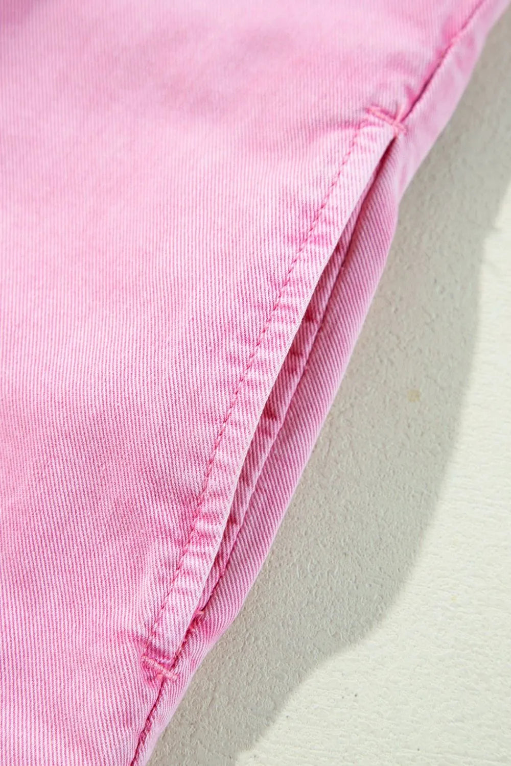 Rolled sleeve denim shirtdress in blush pink with a visible pocket detail.