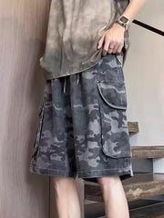 Relaxed fit black camo cargo shorts with multiple flap pockets and drawstring waist.