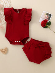 Red ribbed baby set with ruffle trim on flutter sleeves and bloomers.