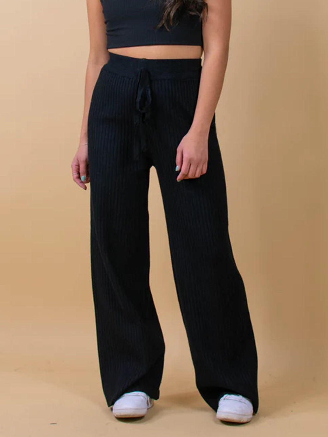 Black ribbed knit palazzo trousers with drawstring waist and wide leg