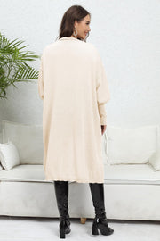 Beige oversized knit cardigan with pockets, long sleeves and a relaxed fit.