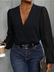 Black bodysuit with plunge neckline and chevron patterned sheer sleeves.