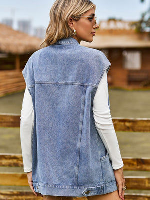 Oversized denim sleeveless jacket in dusty blue with button closure and pockets.