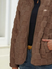 Brown textured grid zip-up jacket with a soft fleece material and a full zip closure.
