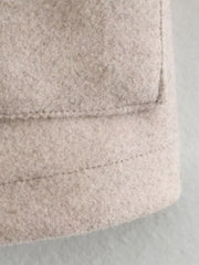 Beige trucker jacket detail showing textured fabric and stitching