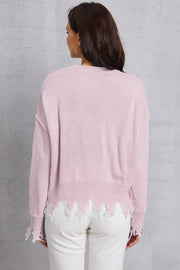 Blush pink acrylic knit sweater with distressed hem and frayed edges.