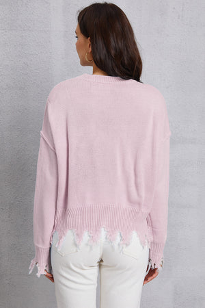 Blush pink acrylic knit sweater with distressed hem and frayed edges.