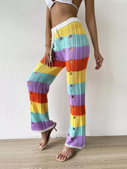 Vibrant crochet knit maternity pants with rainbow stripes and cutout details.