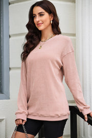 Textured ribbed crewneck pullover in Dusty Pink with long sleeves and a relaxed fit.