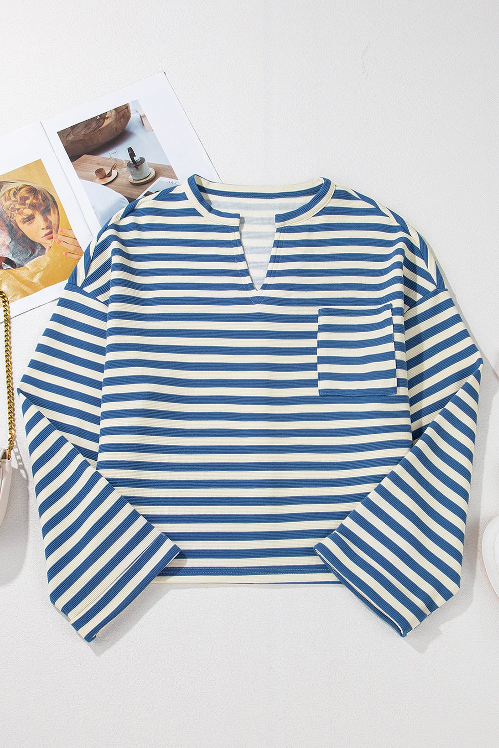 Peacock blue and white striped henley top with chest pocket and v-neck.