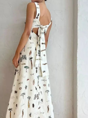Sleeveless maxi dress with vacation print, tie-back detail, and pockets.