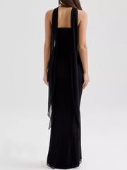 Black sweetheart tube top and flowy maxi skirt set with sheer draped overlay.