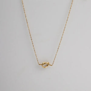 Gold knot pendant necklace with delicate chain, 18K gold-plated.