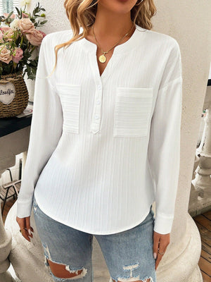 White textured henley blouse with two chest pockets and a v-neck.