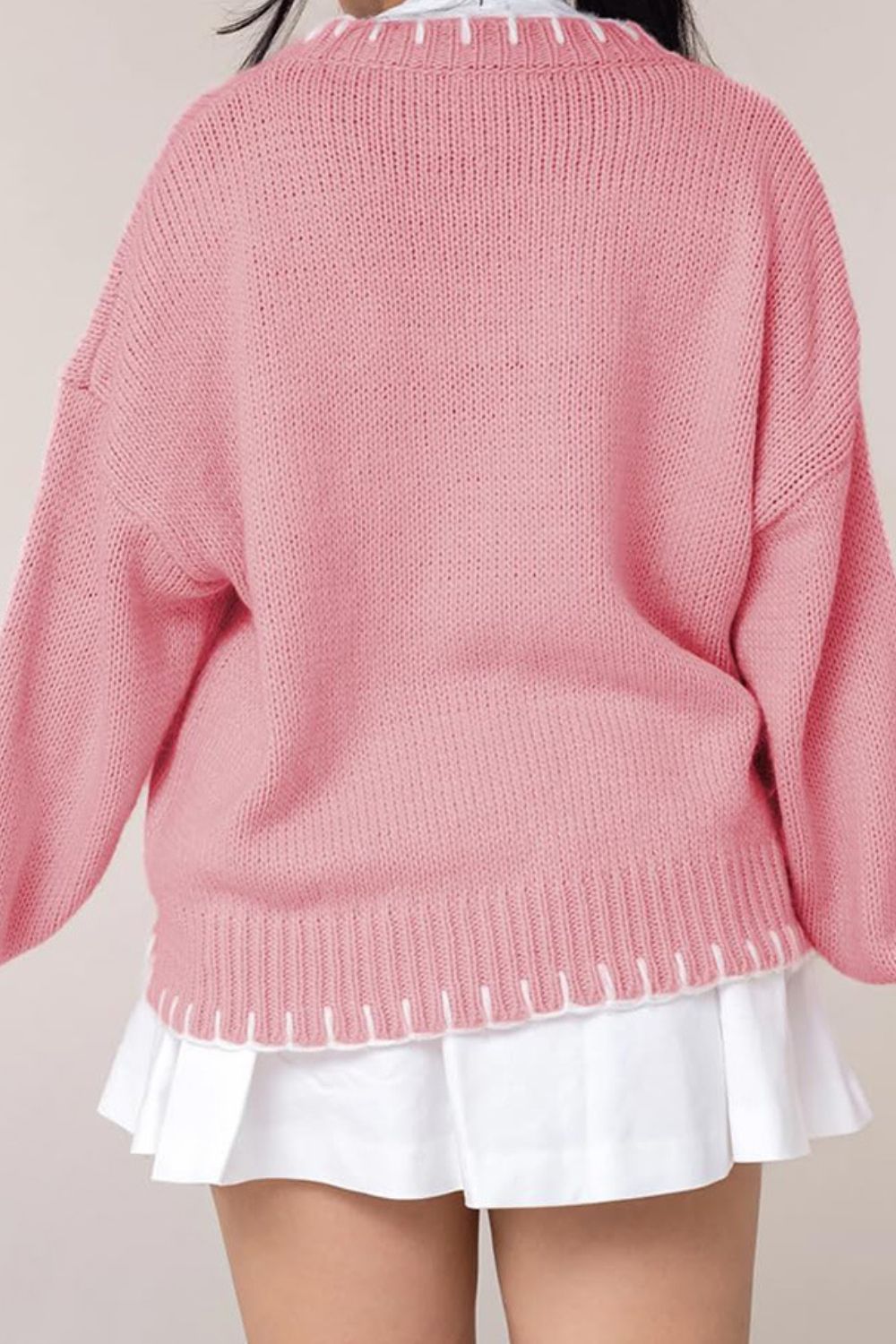 Graphic Bow Knit Crewneck sweater in Blush Pink with white contrast stitching at neckline and hem.