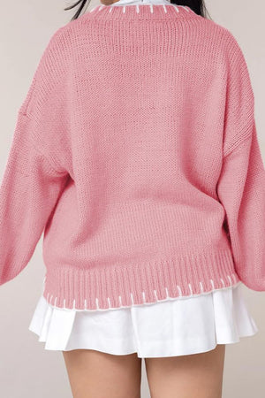 Graphic Bow Knit Crewneck sweater in Blush Pink with white contrast stitching at neckline and hem.