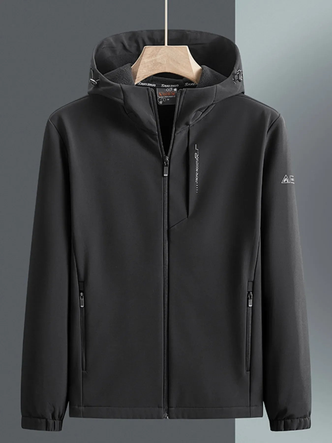 Men's black hooded windbreaker jacket with zippered pockets and subtle chest logo detail.