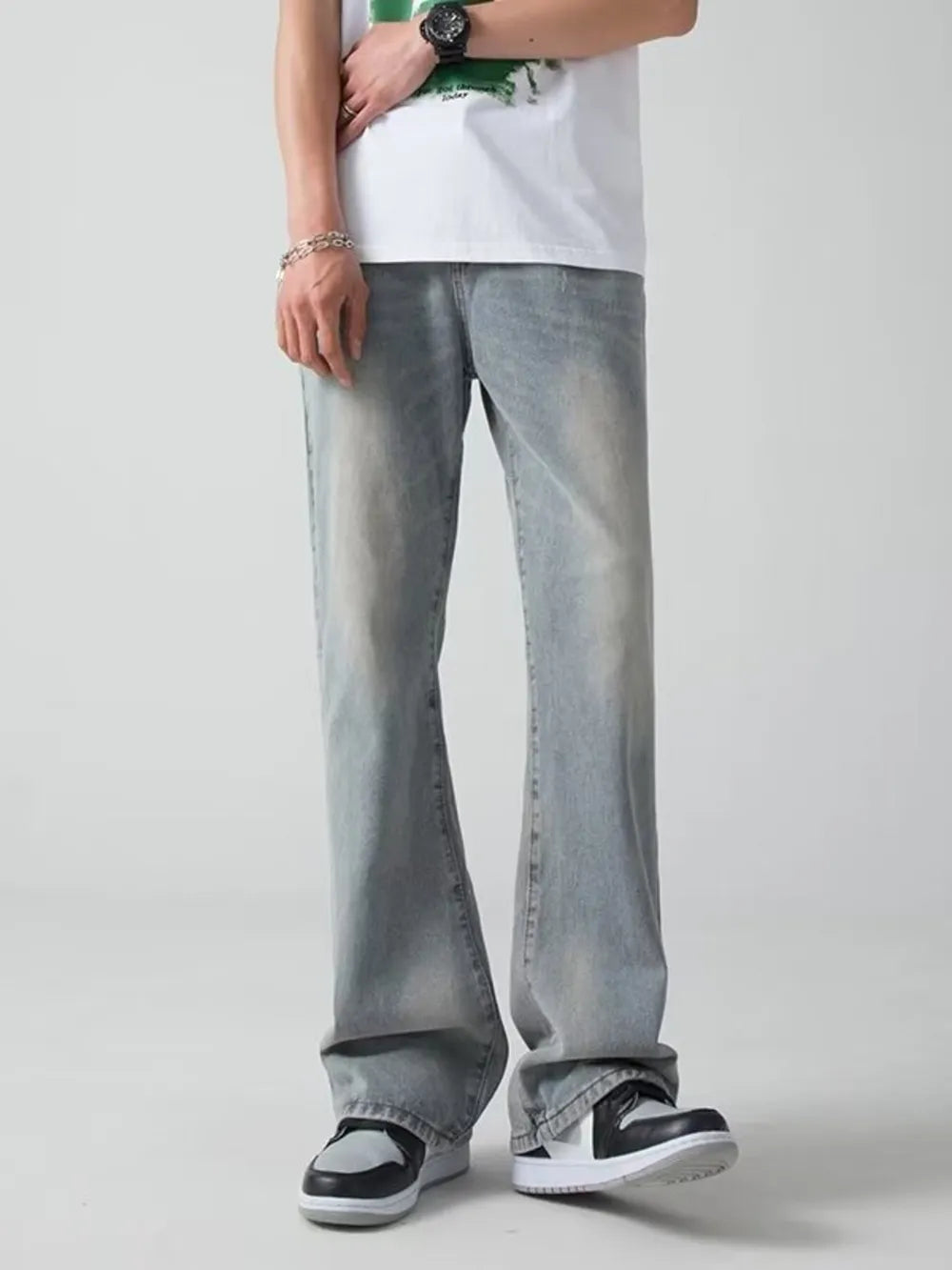 Men's light blue wide-leg jeans with a faded wash and relaxed fit.