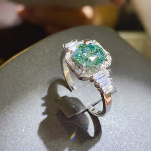 Emerald halo ring with baguette accents in silver.
