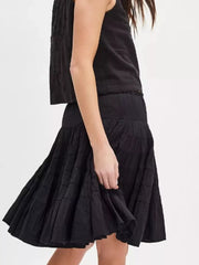 Black tiered drawstring mini skirt with ruffled tiers and a flowy silhouette.