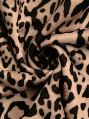 Leopard print jacket fabric detail in tan and black with a textured weave.