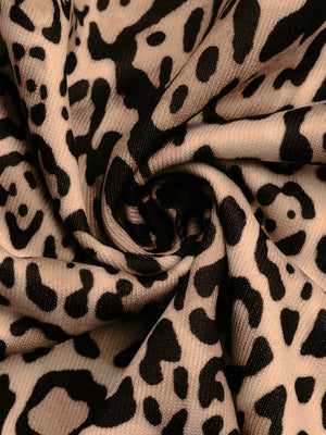 Leopard print jacket fabric detail in tan and black with a textured weave.