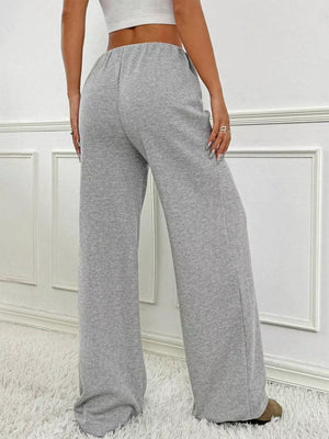Light Gray ribbed wide-leg pants with drawstring waist and a relaxed fit.