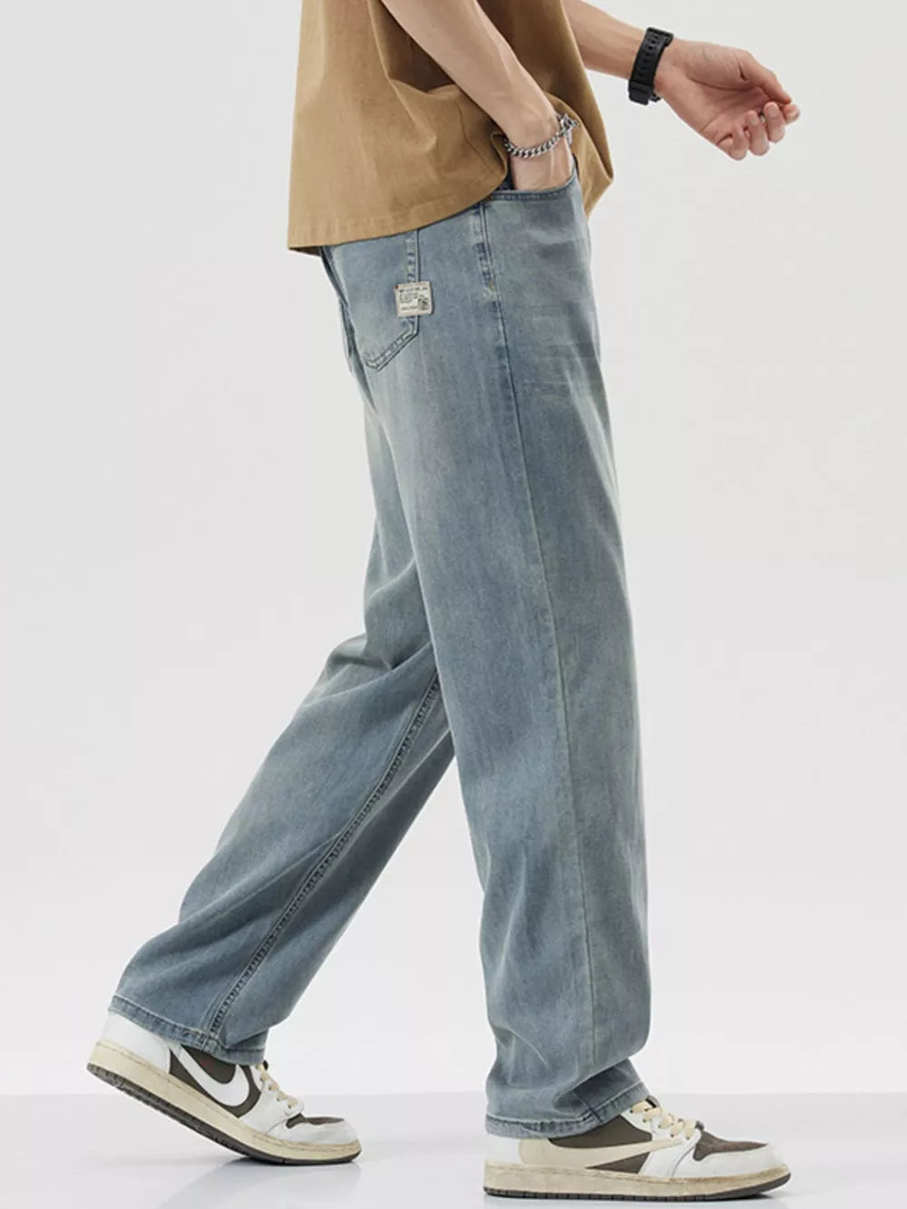 Relaxed fit wide-leg denim trousers in light blue, shown with a casual styling.