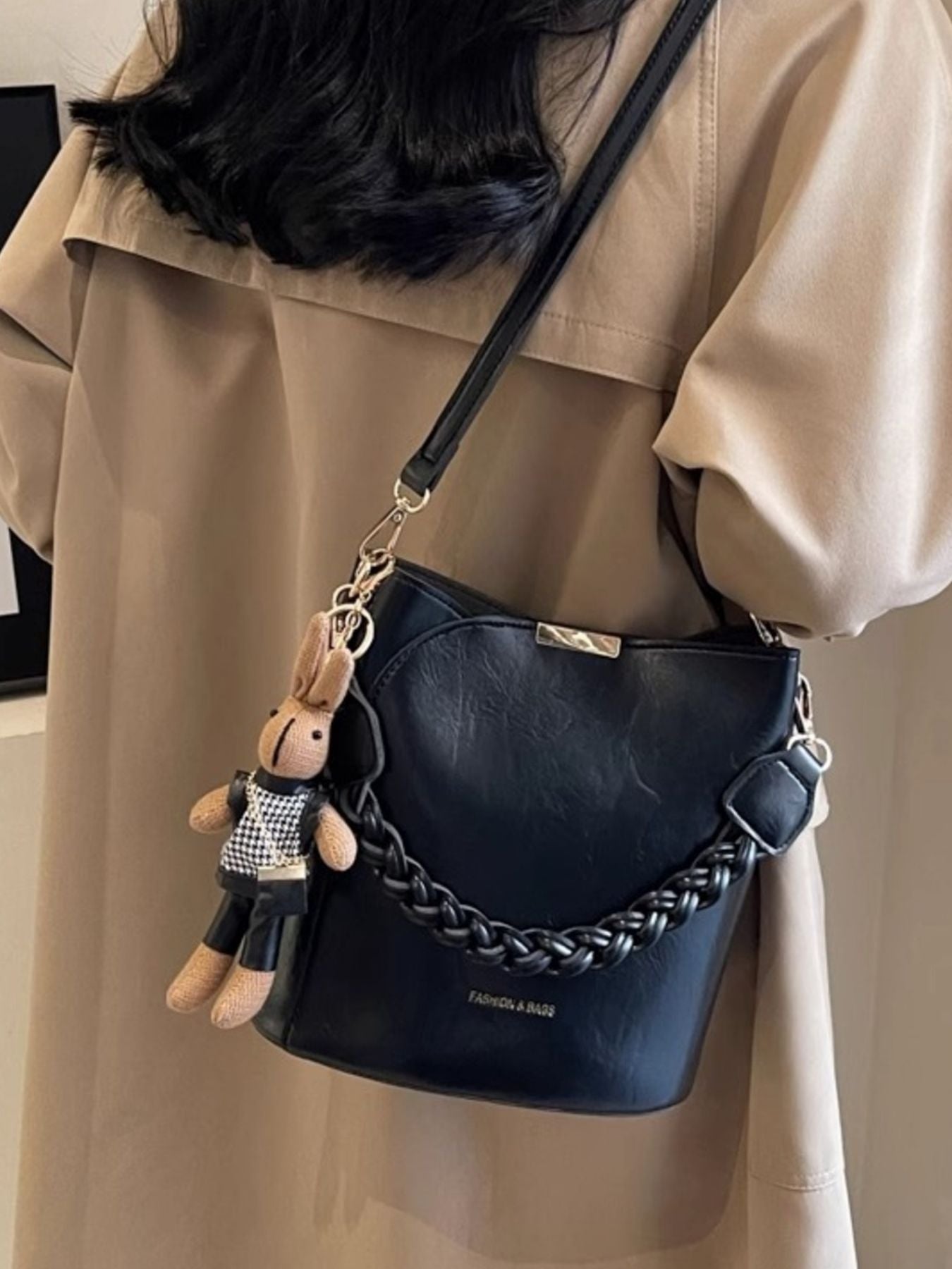 Black braided bucket crossbody bag with bunny charm