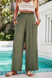 Smocked waist palazzo trousers in Matcha Green with wide legs and pockets.